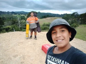 Image of child and father on hill with survey equipment